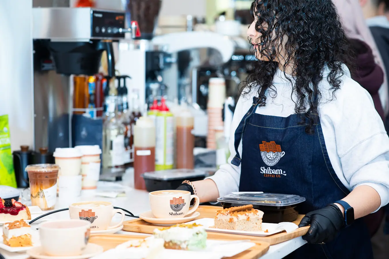 Barista preparing drinks at the coffee bar